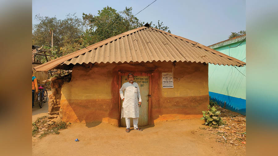 Dipak Mahato outside the tin-roof hut in the village of Jitan in West Bengal’s Purulia district