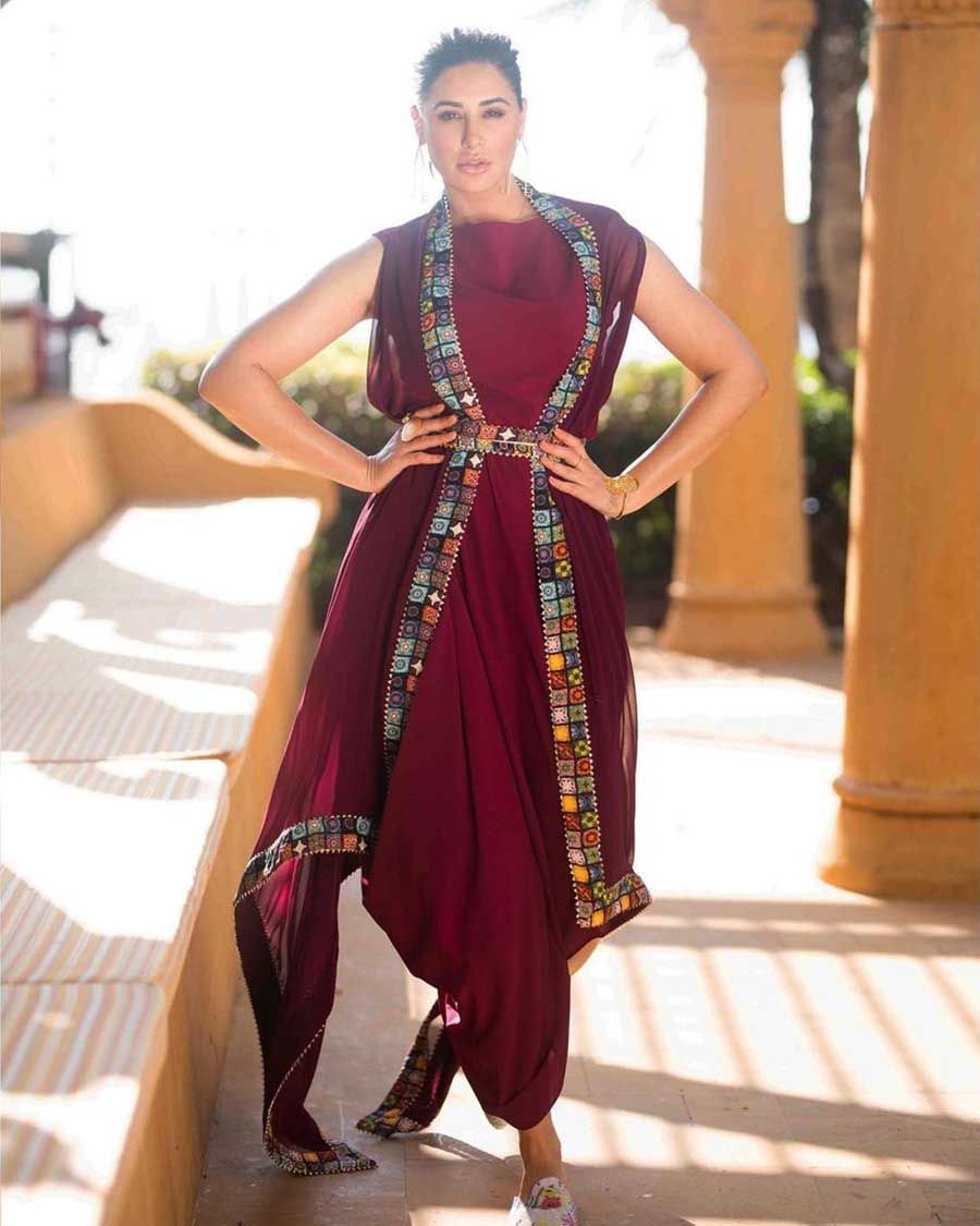 Nargis recently opted for a burgundy dress with a matching jacket and belt. The simple jewellery and high ponytail accentuate her look.