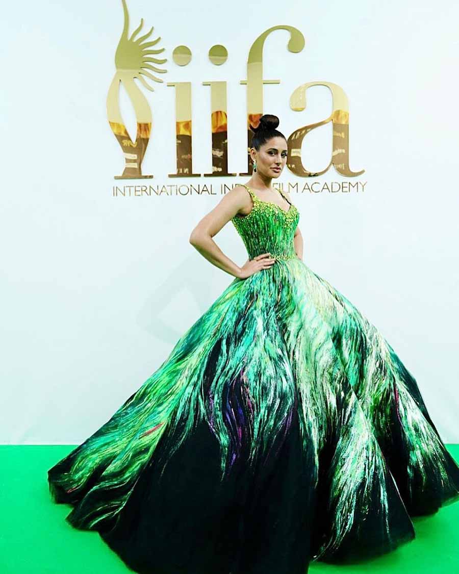 Nargis grabbed eyeballs at the IIFA 2022 with her peacock green fairytale gown. She completed the look with a high bun. 