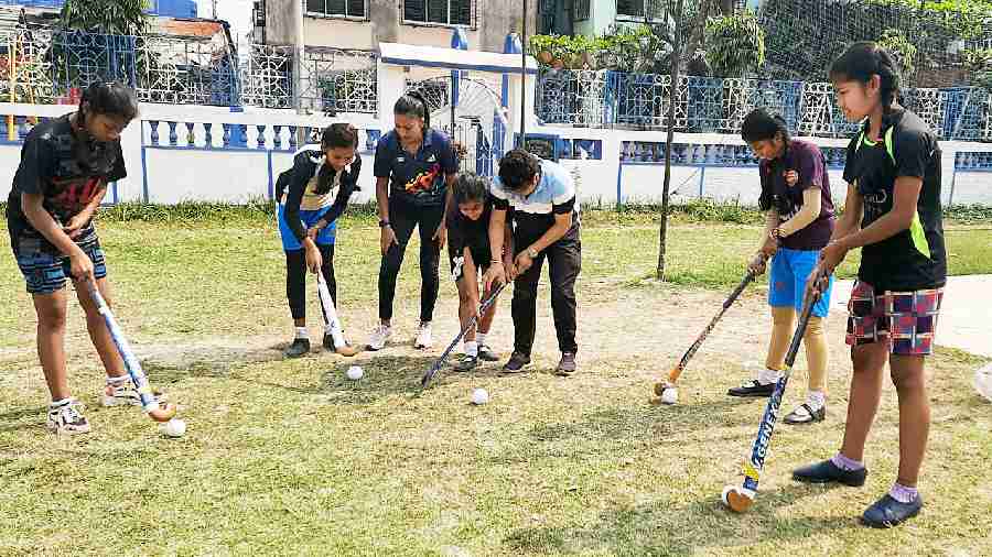 Students of Children’s Welfare Association High School for Girls in Behala at a hockey training session