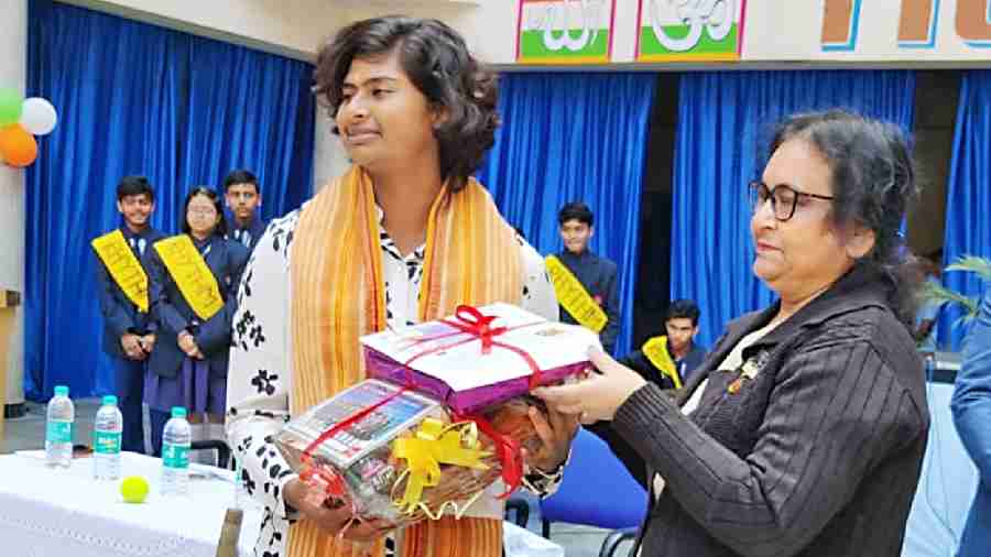 Techno India Group Public School, Hooghly, principal Pradeepta Chatterjee felicitates Titas on the school premises. 