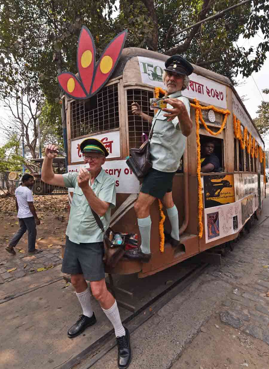 Tony Graham and Roberto D'Andrea, former Melbourne tram conductors, pose with tram cards to promote Tramjatra 2023 at Esplanade tram terminus 