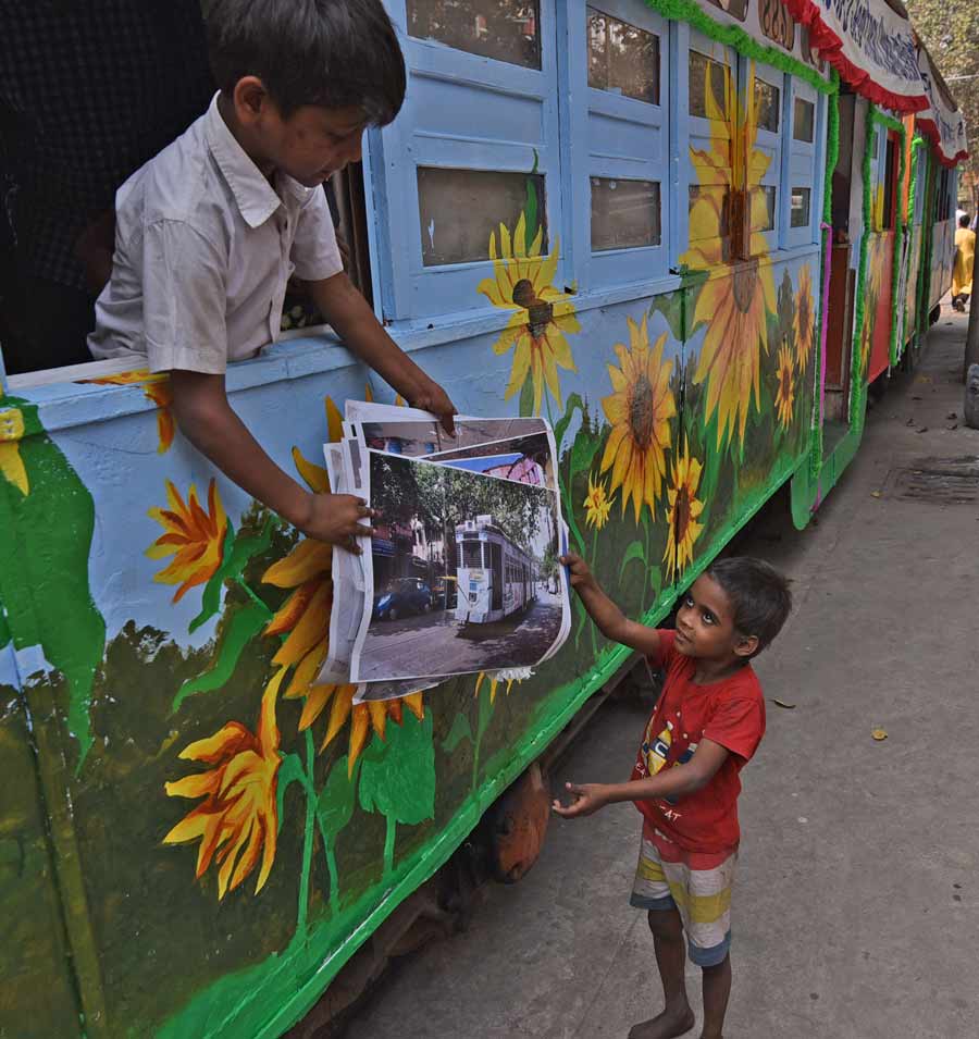 A young boy shows photos of Kolkata trams to his brother. As part of 150 years of Kolkata Tramways, a four-day exhibition on Climate Action Respecting Mother Earth and Green Mobility will begin on February 25 at the Esplanade tram terminus