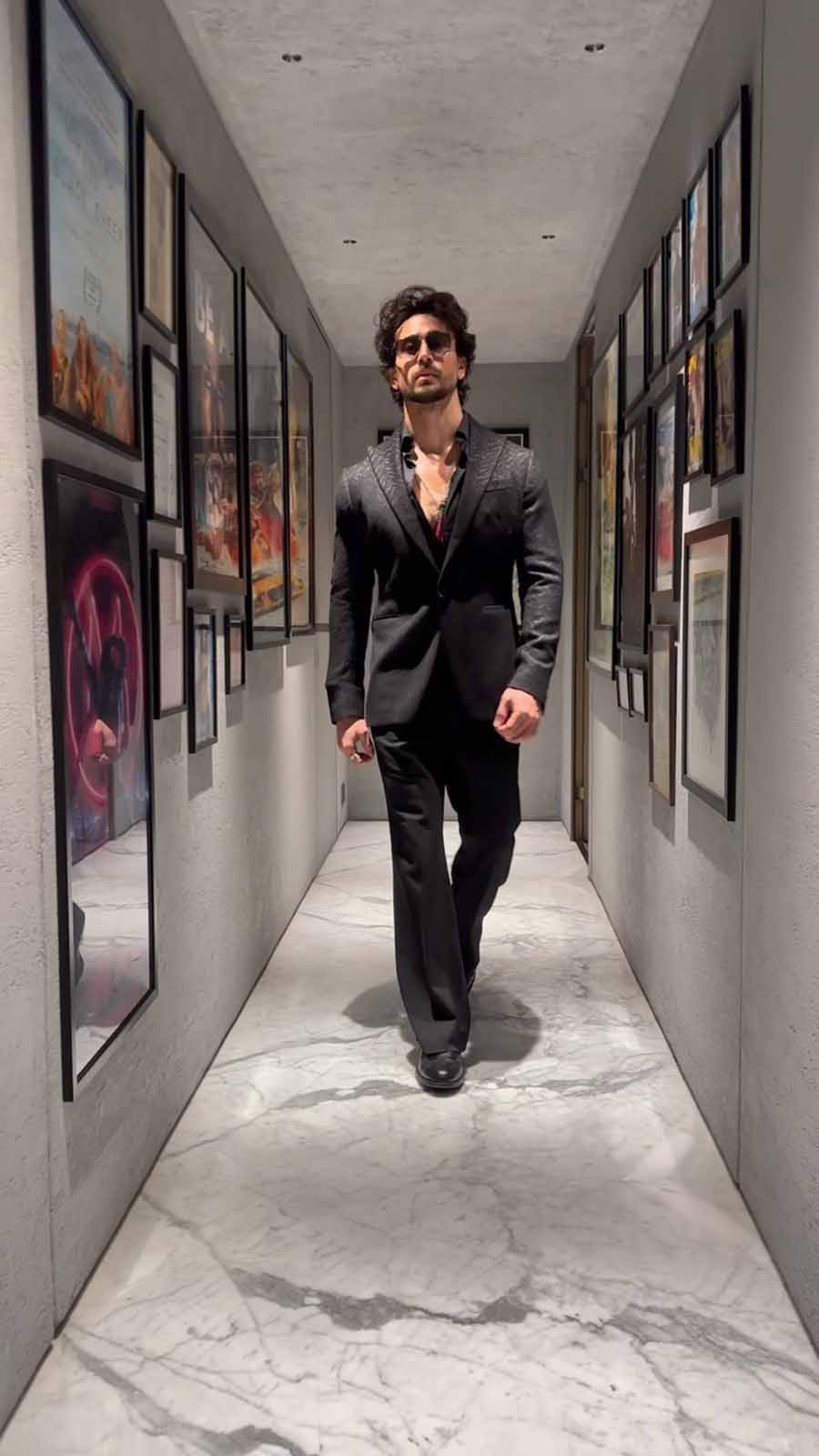 Tiger Shroff looked dapper in a sharp black suit with a matching shirt underneath and sleek silver necklaces to go with it. 