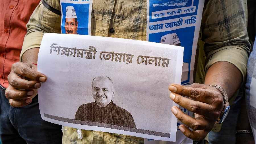 A poster of Delhi Deputy Chief Minister Manish Sisodia held by an AAP worker during a protest over Sisodia's arrest by CBI in the excise policy case, near BJP office, in Calcutta