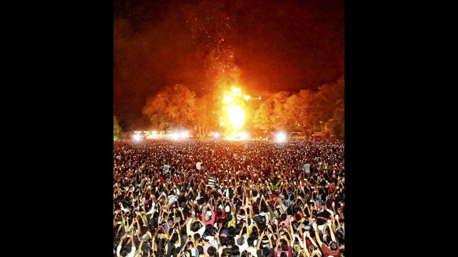 Fireworks explode as people celebrate the New Year 2023 at Fort Kochi. 