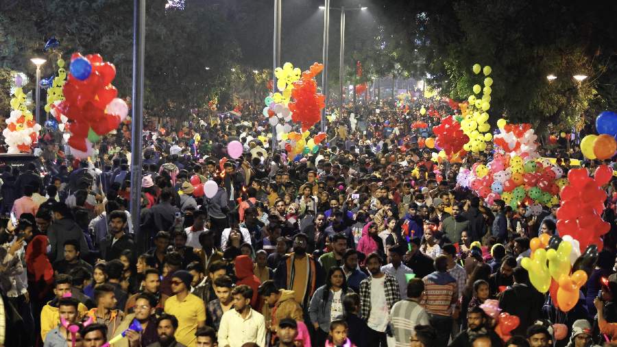 People release balloons as they celebrate the New Year 2023 on a road, in Ahmedabad. 