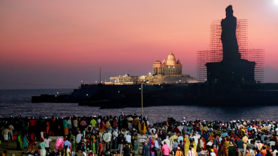 People gather at the beach to witness the first sunrise of the New Year 2023, in Kanyakumari. 