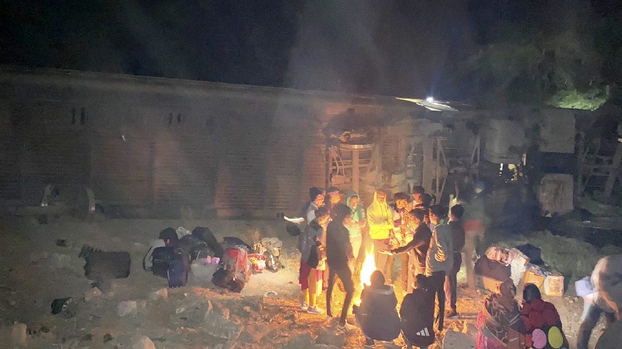 Passengers wait outside the derailed train. The injured, two of them seriously hurt, have been admitted at the Bangad Hospital in Pali, the official said. 