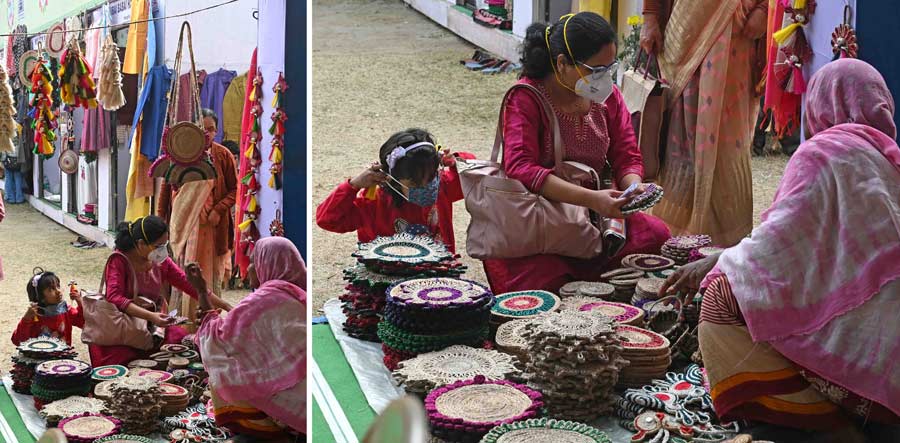 A mother and daughter duo take their pick from a stall. The items at the fair appeal to people of all ages. Wary of the COVID scare, many visitors were spotted wearing masks