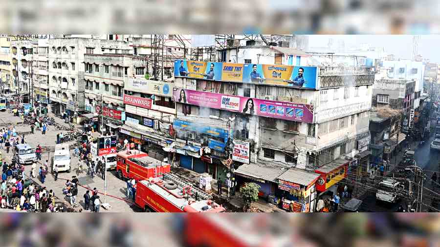 Smoke wafts out of a window of the Baguiati branch of Canara Bank on Wednesday morning. 