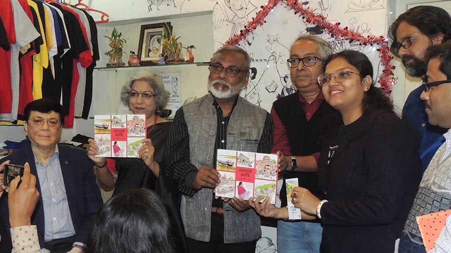 Debashis Deb flanked by his wife (second from left), professor Dipankar Ghosh (fourth from left) and other guests at the book launch