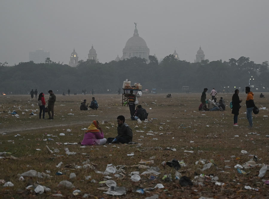 Visitors sit in a litter-strewn Maidan on Thursday