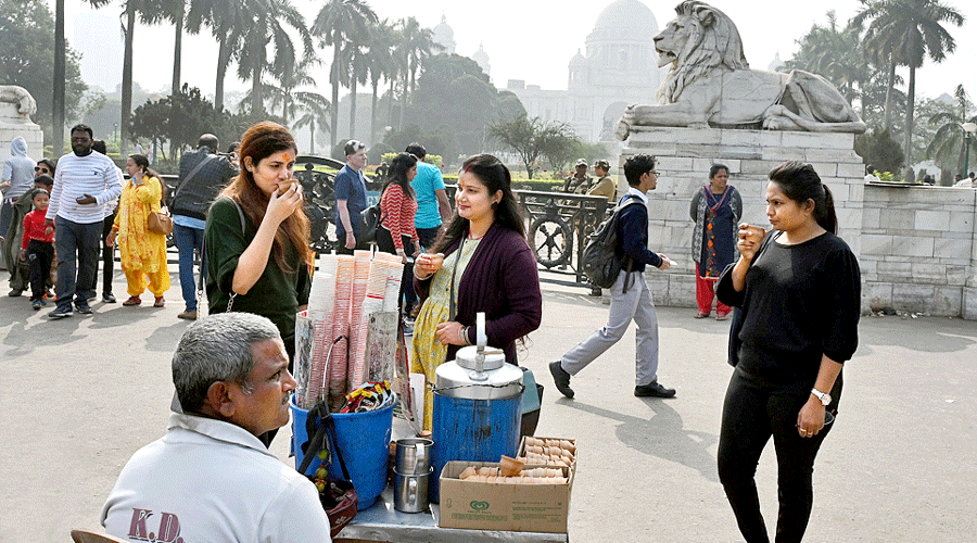 Visitors to the Victoria Memorial sip hot tea on Thursday afternoon.