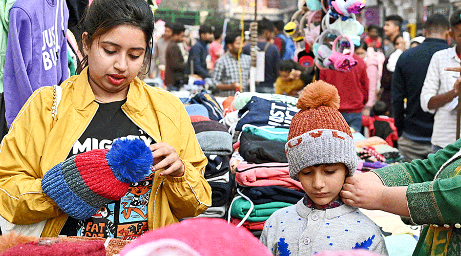 Shoppers buy woollens in New Market.