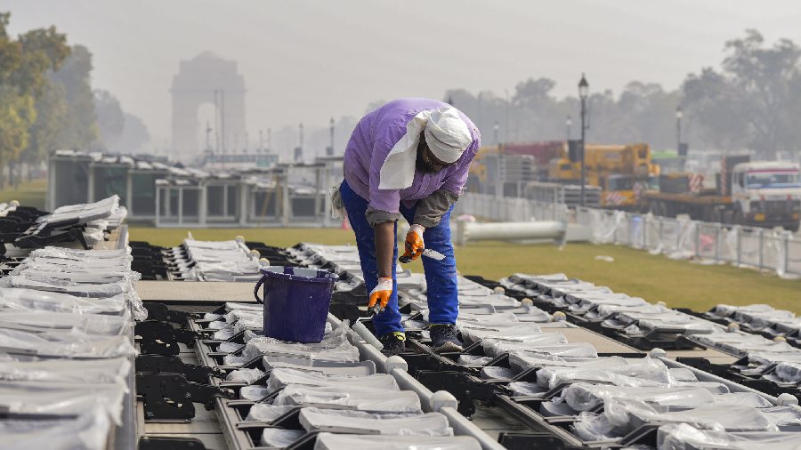 A worker paints in a visitors' enclosure as part of preprations. 