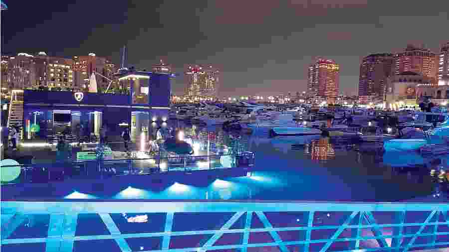The Lamborghini Lounge — this was the evening view and it did attract attention even among the high-end boats — was docked at the Pearl marina in Doha during the FIFA World Cup 2022. It travels from place to place, mostly with events, and owners of cars with the fighting bull on its nose can drop by for eats and drinks. At the watch boutique  on the upper deck, one can buy Lamborghini co- branded Roger Dubuis watches that are specially  designed with cues from Lamborghini cars. There are open sitting areas on both the upper and lower decks where one can have a drink or a coffee and enjoy the view of the marina. The Lounge was assembled at Doha just before the quarter-final matches and remained for the duration of the World Cup.