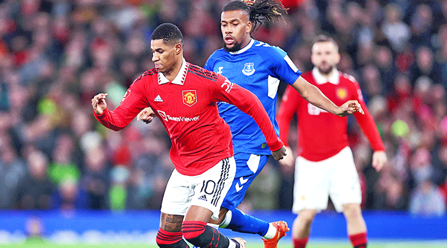 Manchester United’s Marcus Rashford (front) beats his marker Alex Iwobi of Everton during the FA Cup match at Old Trafford on Friday.