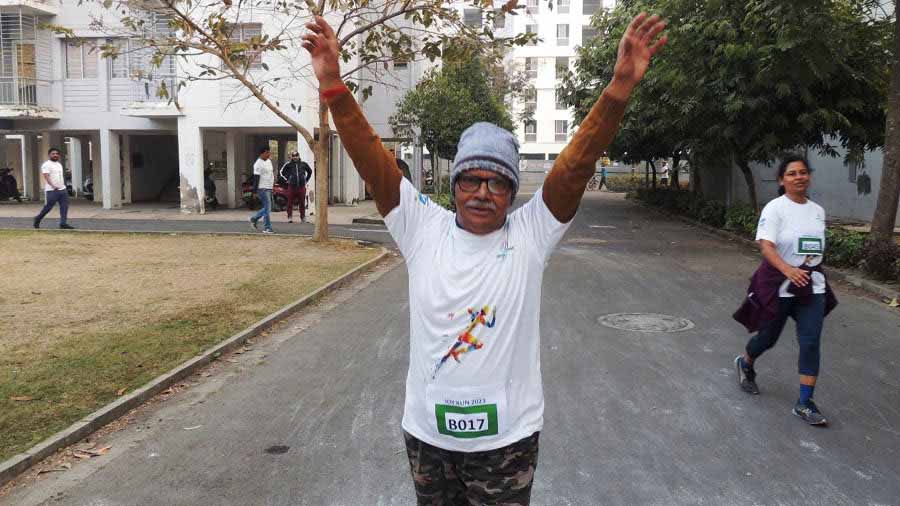72-year-old Dhiren Mitra crosses the finish line