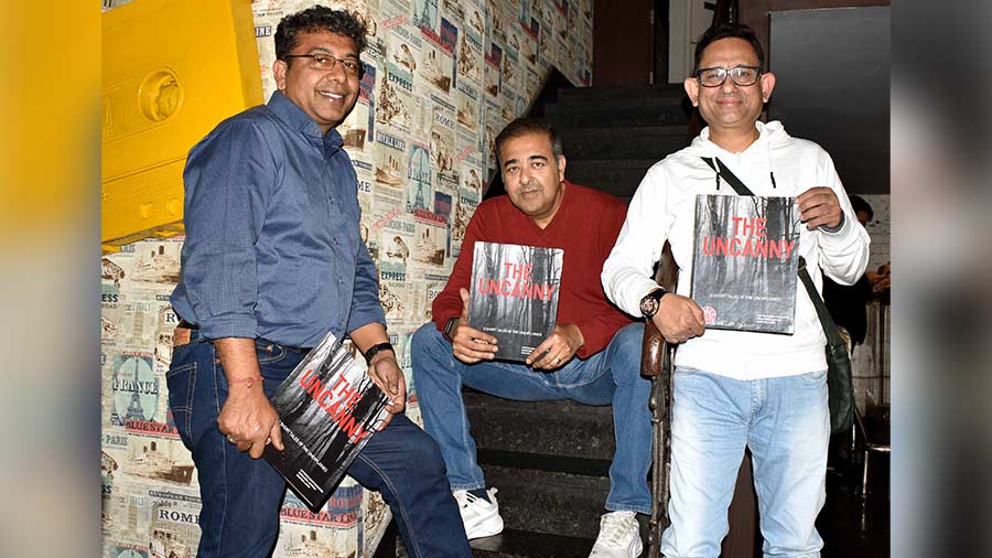 (L-R) Gautam Lahiri, Indraneel Ganguli and Diptarag Bhattacharjee pose with copies of their book