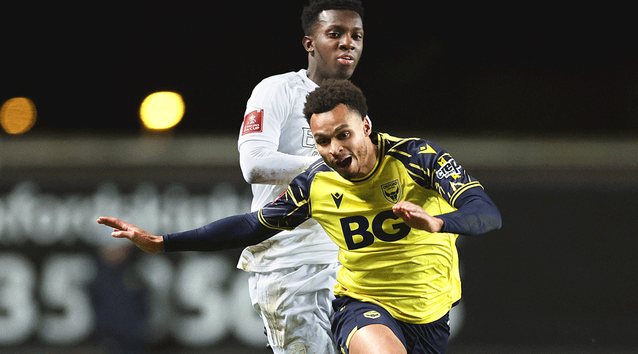 Josh Murphy (front) of Oxford United is tackled by Arsenal’s Eddie Nketiah during their FA Cup third round match on Monday.