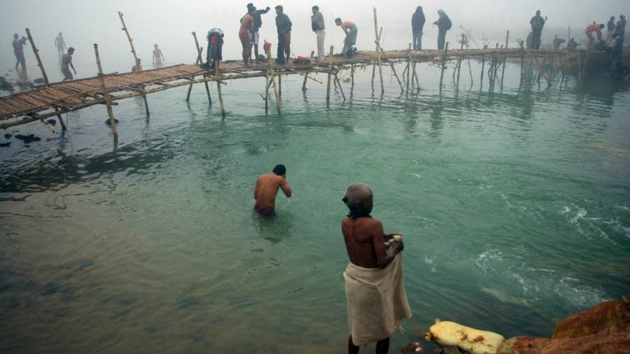 Devotees taking a bath in Ajay River during Makar Sankranti