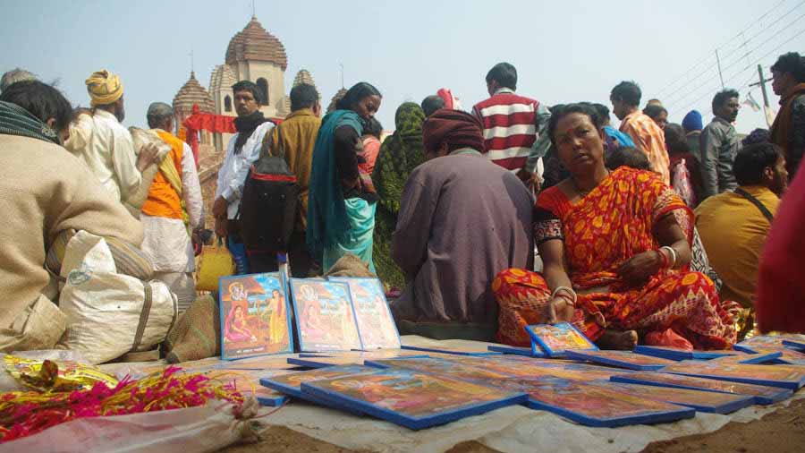 A woman selling paintings of poet Joydev and his wife Padmavati in front of Radhabinod temple