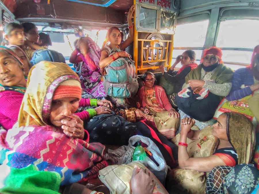 Gangasagar pilgrims ride a crowded bus at the Park Street crossing on Thursday