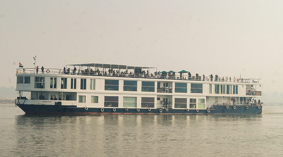 People aboard the world's longest river cruise MV Ganga Vilas after it was flagged off by Prime Minister Narendra Modi during a ceremony, in Varanasi.