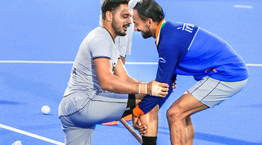 Harmanpreet Singh (left) in good mood with teammate Hardik Singh on Saturday.
