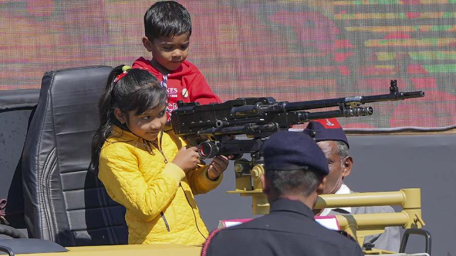 Children play with a gun during the event. 