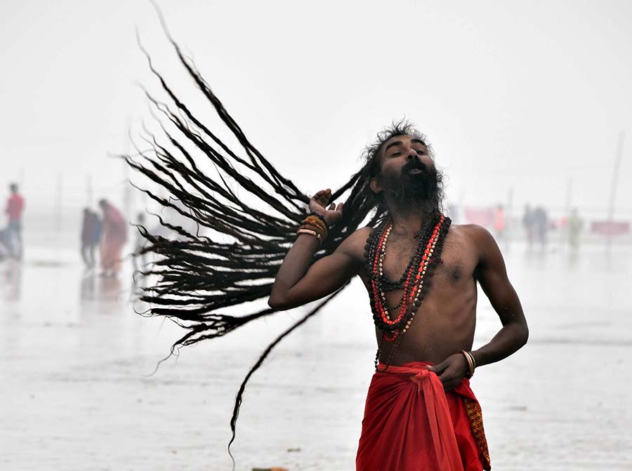 A ‘sadhu’ dries his hair after a dip at the Gangasagar Mela. January 15, 2023, turned out to be warmest Sankranti in 53 years with a maximum temperature of 27.5 degrees Celsius and a minimum temperature of 19.7 degrees Celsius 
