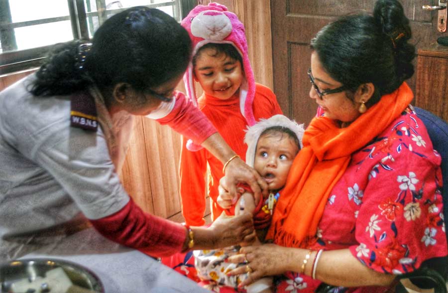 A young child gets a vaccine shot at the measles and rubella vaccination camp arranged at Press Club, Kolkata, on Monday