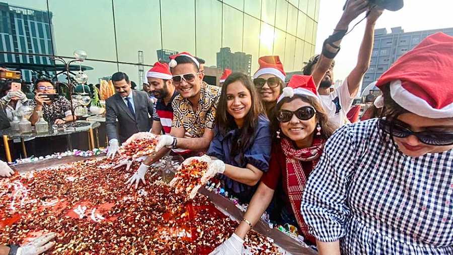 Members of Young Indians (YI) Kolkata Chapter get their hands dirty during the cake-mixing ceremony. With cute Santa hats, the vibe was one of fun and frolic and it was a great photo-op as well.