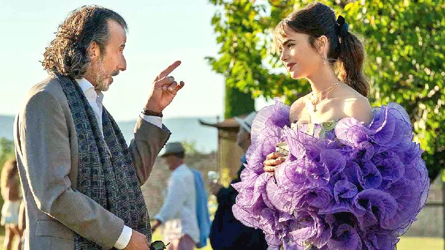 A Giuseppe Di Morabito corseted floral dressthat’s cinched at the waist is paired with anH&M x Iris Apfel purple tulle-ruffle jacket