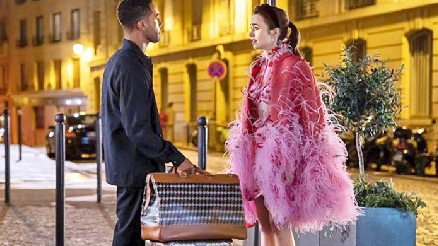 A mini cutout Magda Butrym dress is layered with a dramatic pink feather coat