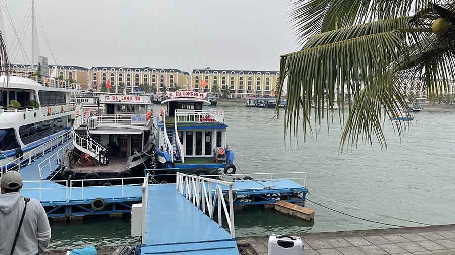A three-hour drive from Hanoi takes you to Tuần Châu port at Ha Long Bay, where you board a tender boat that takes you to your luxury cruise ship. The 20-minute boat ride is a scenic journey, with emerald green waters and limestone rock formations rising out of it