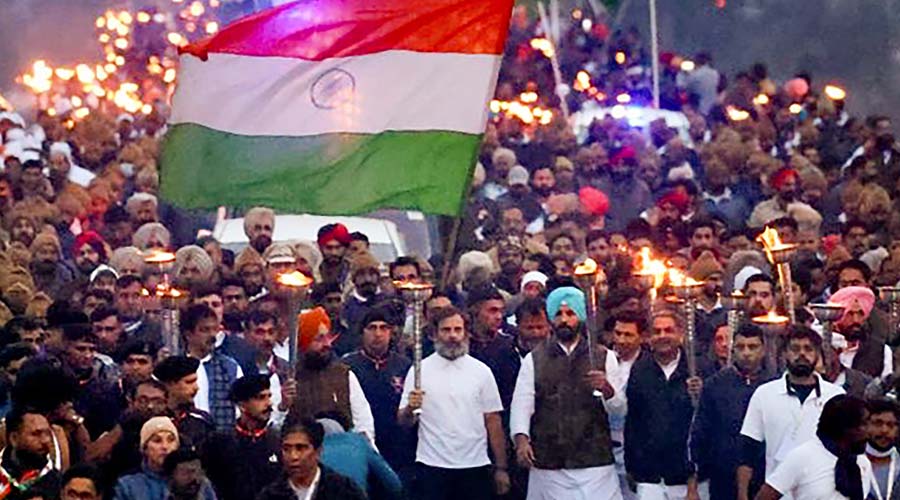 Congress leader Rahul Gandhi carries torch with party leaders and supporters during the party's Bharat Jodo Yatra at Lakhanpur border in J&K.