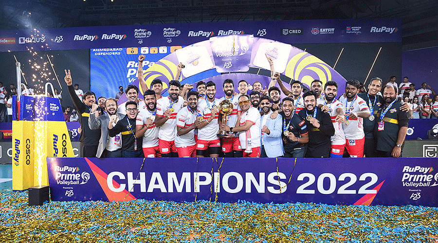 Kolkata Thunderbolts players and support staff with the trophy after winning the Prime Volleyball League in 2022.