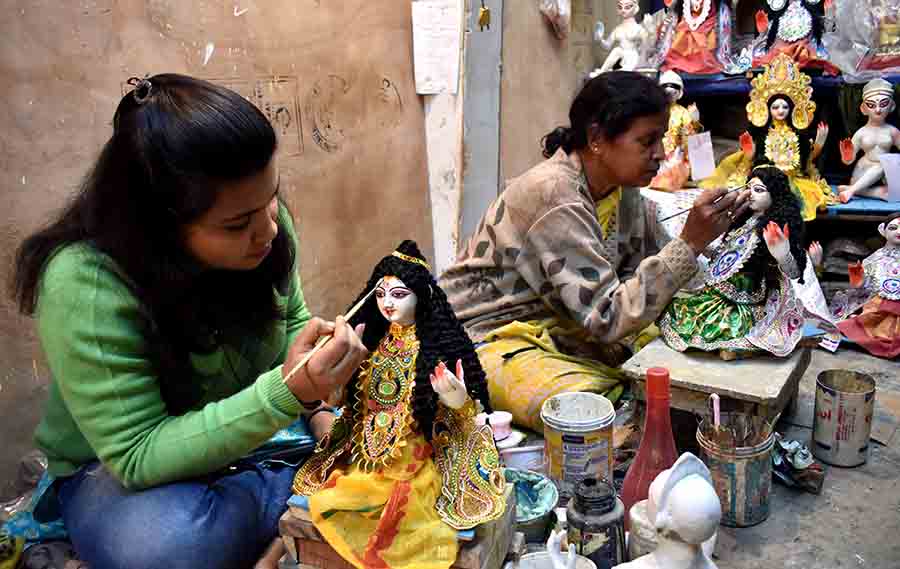 Mother-daughter duo Mala Paul and Beauty Paul lend finishing touches to idols of Goddess Saraswati at Kumartuli on Saturday