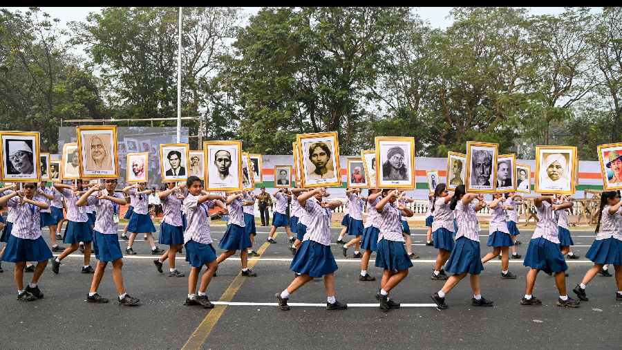 School students carry portraits of freedom fighters during the full dress rehearsal of the Republic Day parade in Calcutta.