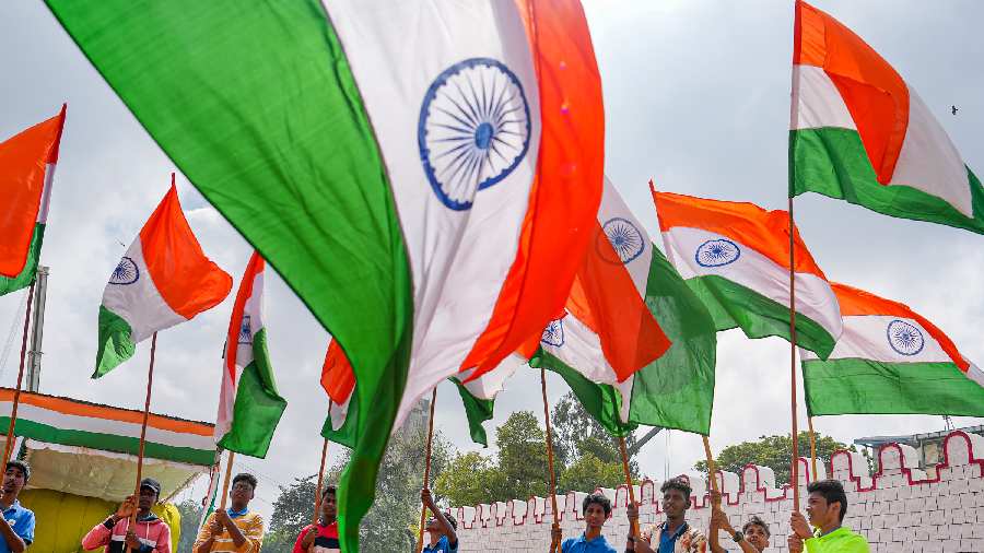 Students holding the national flag take part in the full dress rehearsal of the Republic Day Parade at Manek Shaw parade ground in Bangalore.