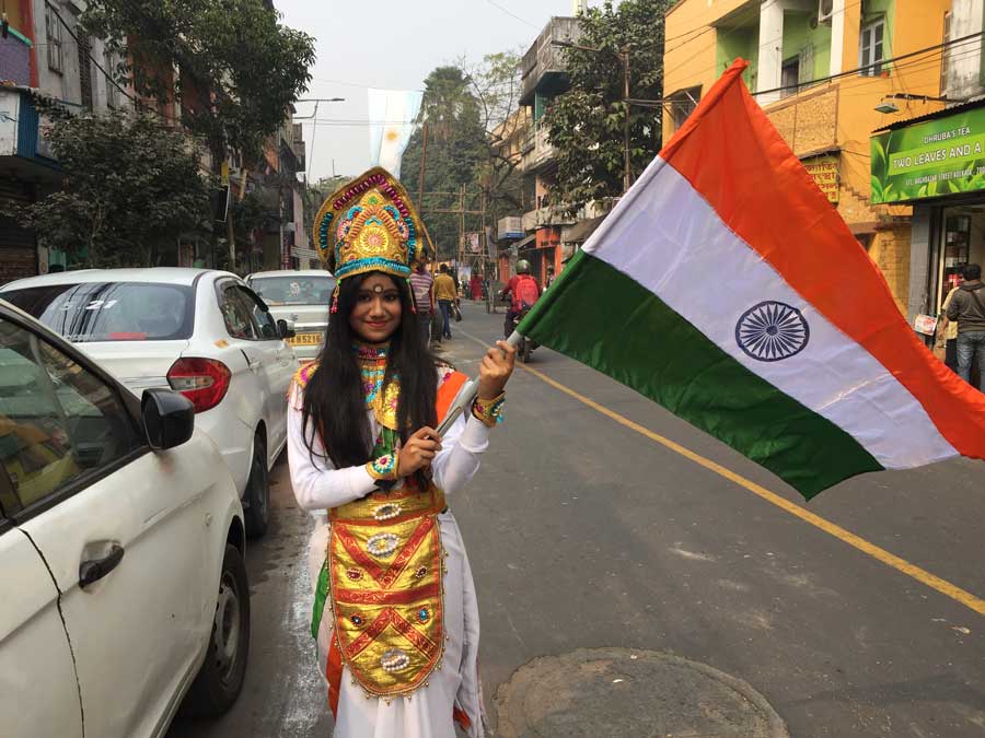 As schools gear up for Republic Day celebrations, a school student poses with the Tricolour in north Kolkata