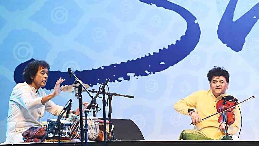 Zakir Hussain on the tabla and Ganesh Rajagopalan plays the violin at a performance by Indo-jazz band Shakti at CC&FC on Tuesday evening. 