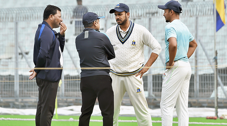 Bengal captain Manoj Tiwary (second from right) and his Odisha counterpart Subhranshu Senapati with the two on-field umpires after one of the four pitch inspections at the Eden on Tuesday.