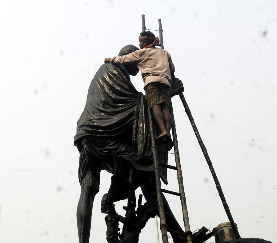 A statue of Mahatma Gandhi at Mayo Road gets cleaned up before Republic Day celebrations begin in the city