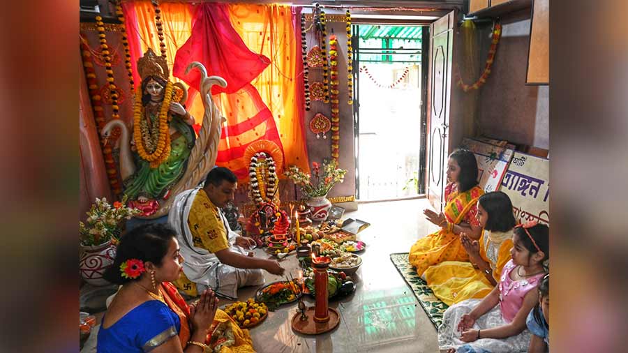 Pupils of a music school in Baguiati pray to the goddess of knowledge during a Saraswati Puja ceremony