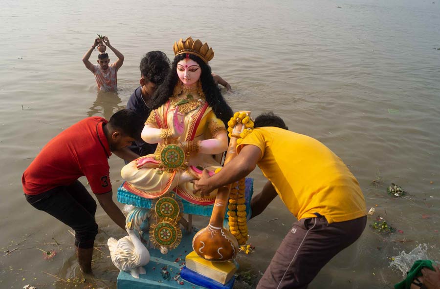 Devotees immerse an idol of Goddess Saraswati at Nimtala Ghat on Friday