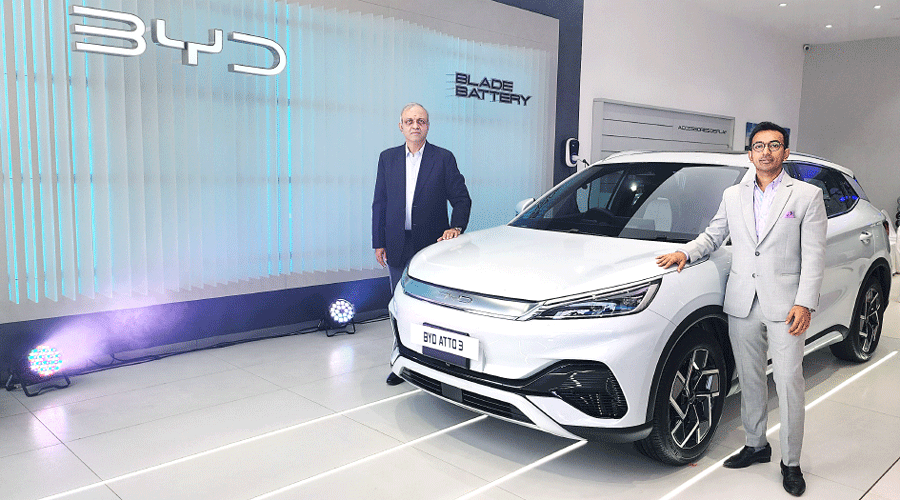 Sanjay Gopalakrishnan, senior vice-president, electric passenger vehicle business, BYD India, and (right) Nitin Himatsingka, director, Karini BYD, at the opening of the showroom for electric vehicles in Kasba on Friday.