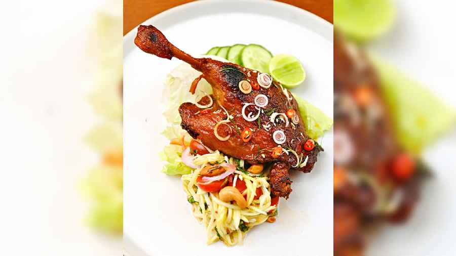 Phed Yang: Tender barbequed duck leg is served on a bed of raw mango salad, with cashew nuts and mint. The rich meaty feel of the duck is cut through by the tart and zingy salad and the plate is a well-balanced one.
